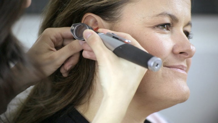 Otoscopic examination on a woman for ETI training videos